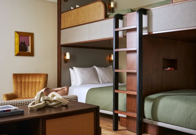 Modern wooden bunk beds with woven cane accents furnish a room with hardwood floors and a golden armchair. Text: PARIS MUSEE D'ORSAY, DREAMING WITH ABREUN, LITTLE, V.