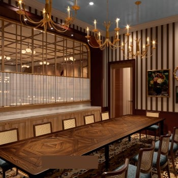 A long, ornate wooden dining table with chairs fills a luxurious room featuring striped walls, multiple artworks, golden chandeliers, and a glass-paneled partition.