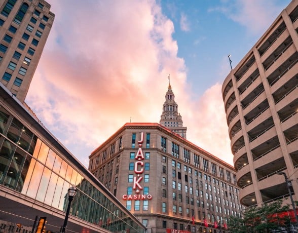 Jacks Casino skyline at sunset, with vibrant orange and purple hues illuminating the buildings and streets below.
