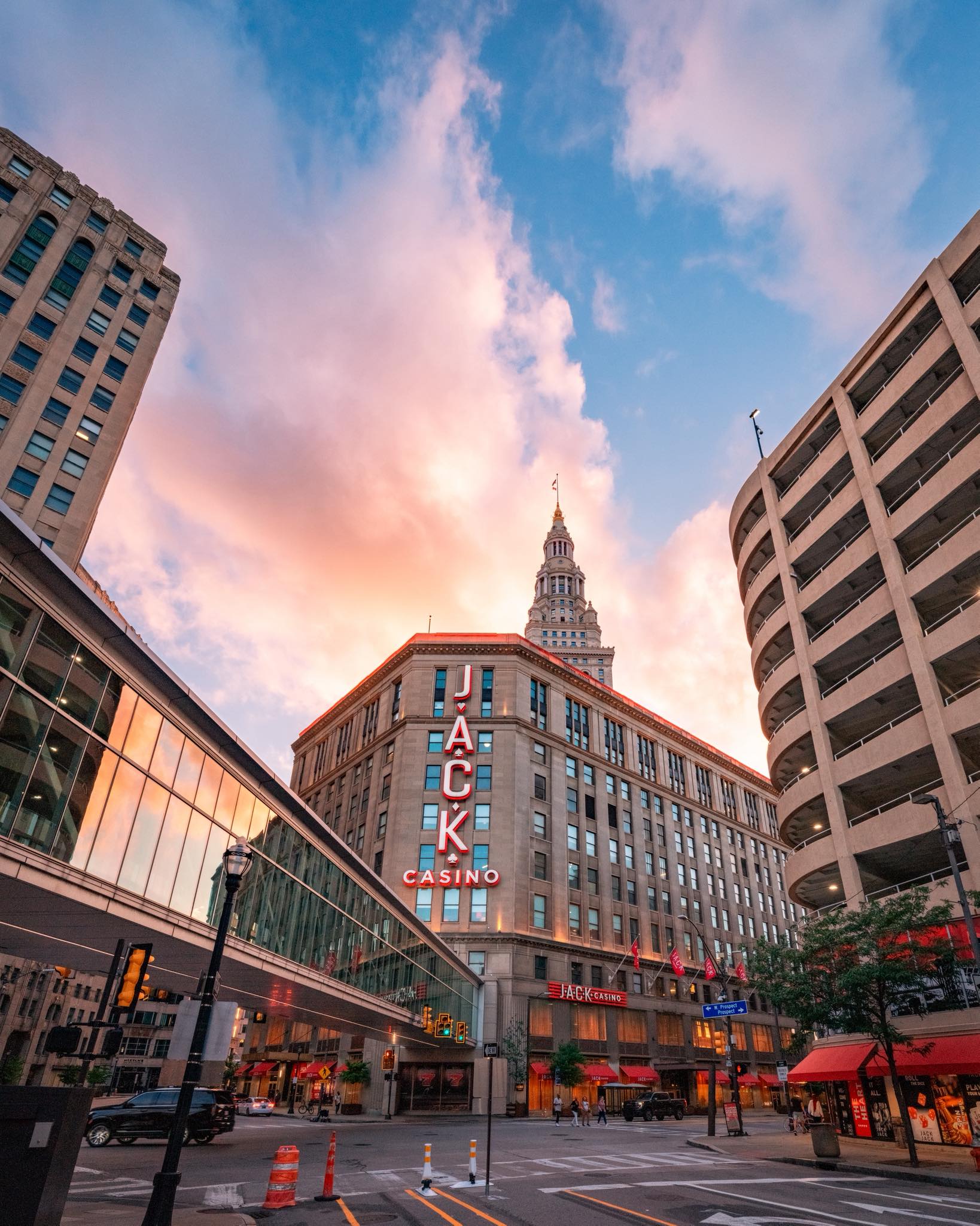 Jacks Casino skyline at sunset, with vibrant orange and purple hues illuminating the buildings and streets below.
