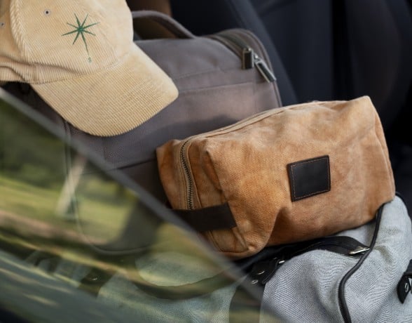 A cap and bags in the front seat of a car.