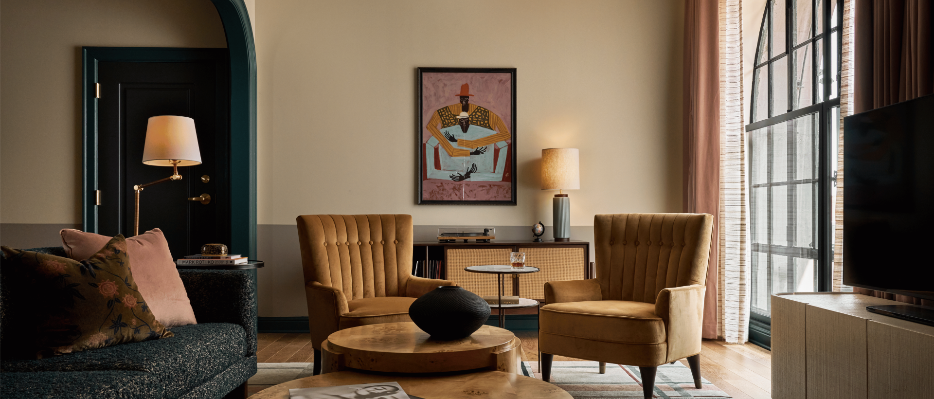 two chairs in front of art in hotel suite