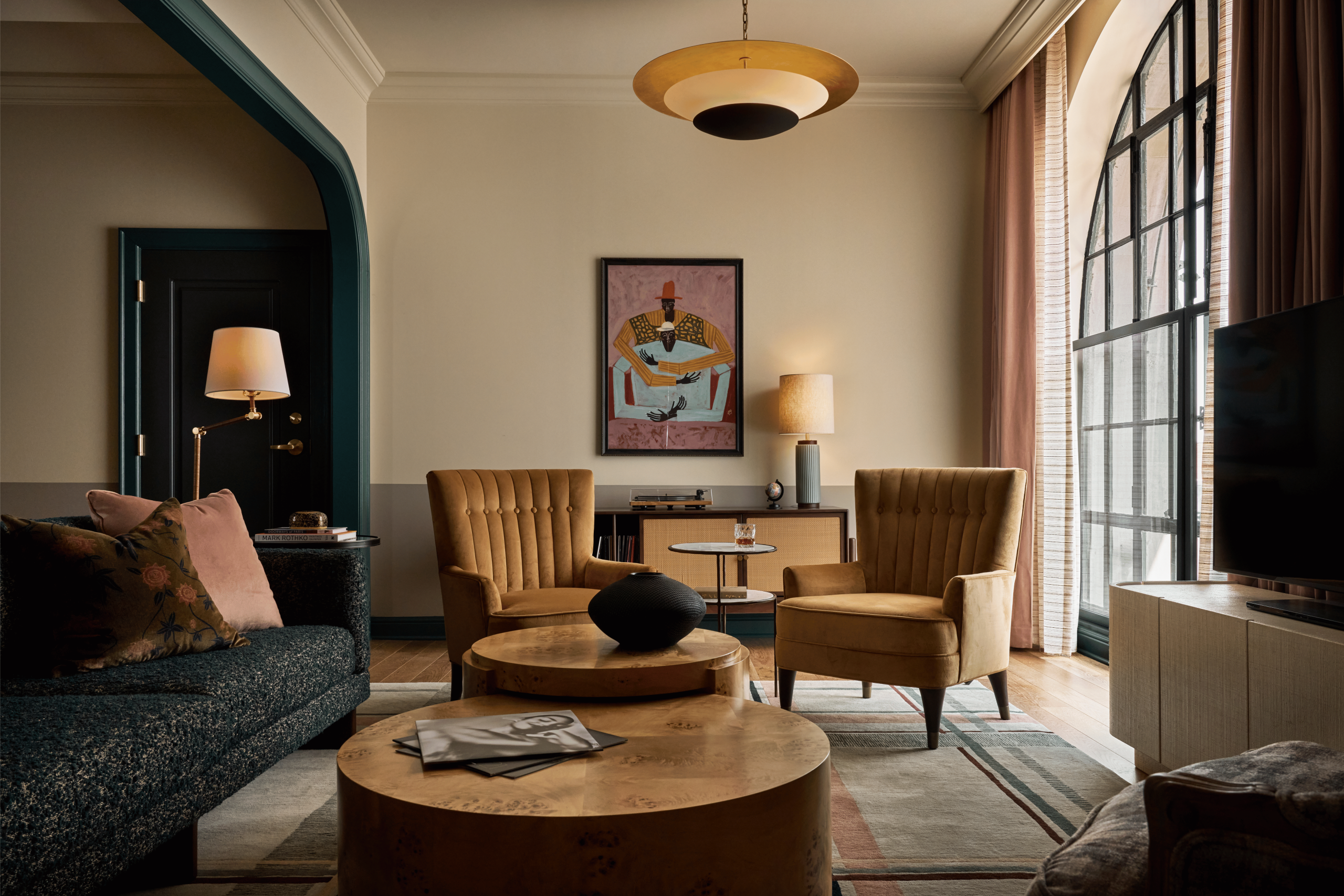 two chairs in front of art in hotel suite