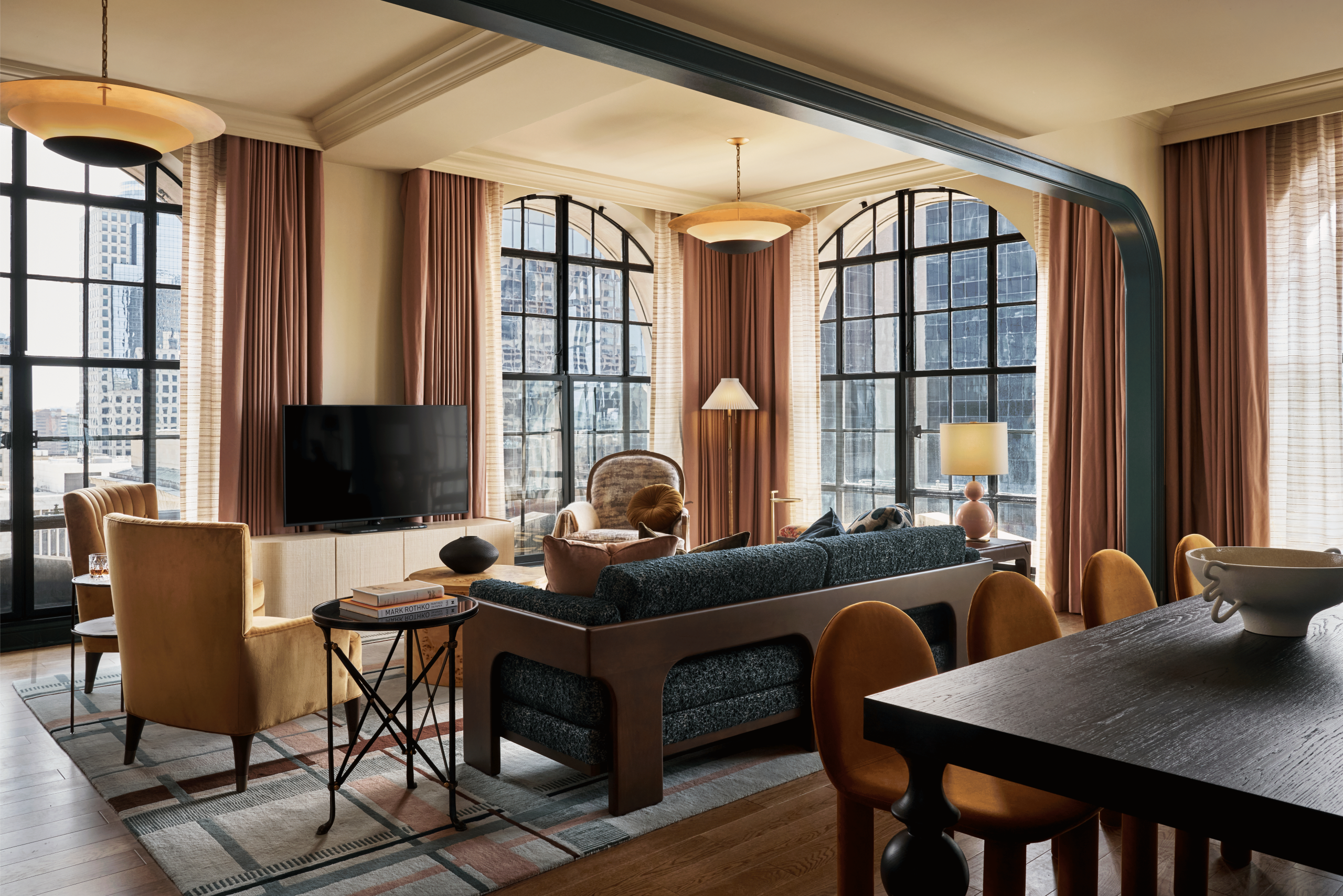 living room area in hotel suite with TV, couch, lamp and coffee table